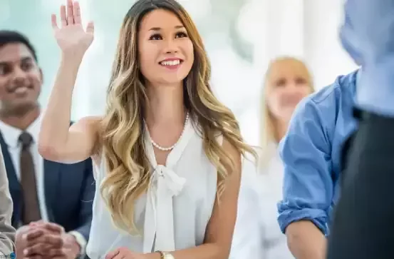 Woman raising hand to ask a question